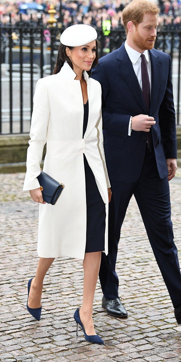 Meghan Markle, 36, today looked chic in navy and white as she stepped out in Ama...