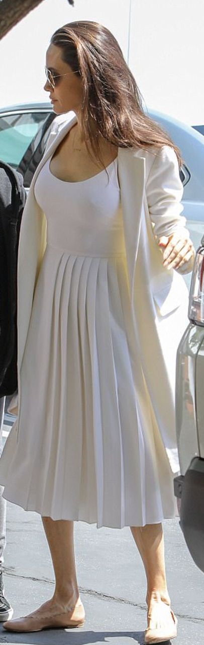 Who made  Angelina Jolie's tan ballet flat shoes and white pleated dress?