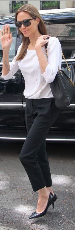 Angelina Jolie: Sunglasses and purse – Saint Laurent  Pants and shirt – Mich...