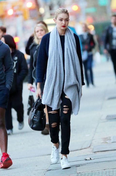 Gigi Hadid in Joe's Finn Skinny Ankle jeans, a navy sweater, and White + War...