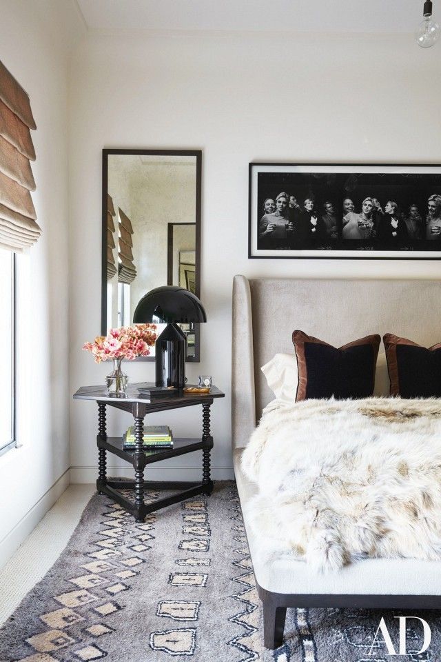 Kourtney Kardashian's bedroom with a vintage rug, a nude headboard, and a fa...